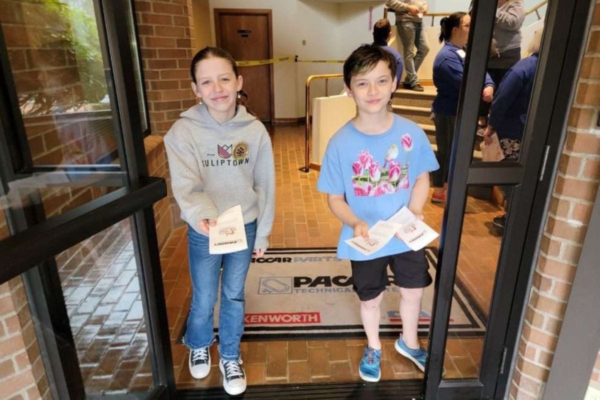 Two young tulip ambassadors handing out flyers