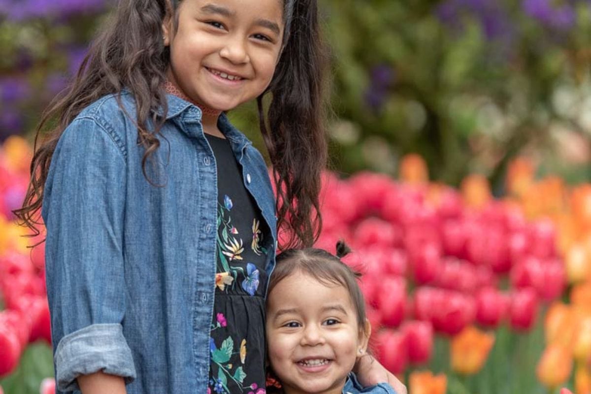 Kids enjoying vibrant tulips at Skagit Valley Tulip Festival.