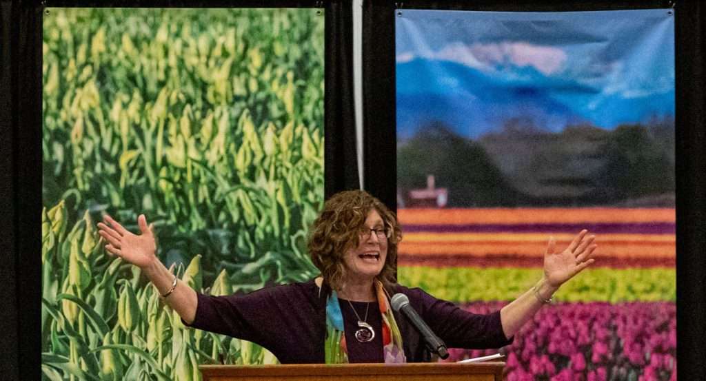 Cindy speaking with arms wide