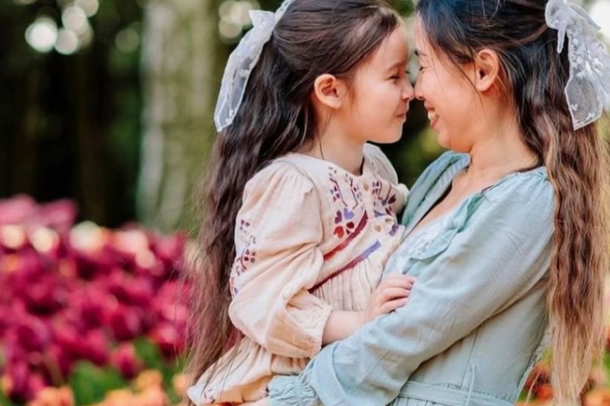 Beautiful mother and daughter sharing a joyful moment among colorful tulips at Skagit Valley.