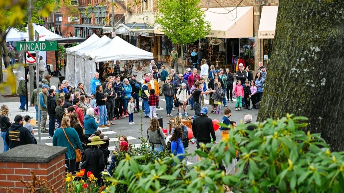 Crowd gathered at the intersection of Kincaid Street in Mount Vernon watching live performers during the Skagit Valley Tulip Festival Street Fair.